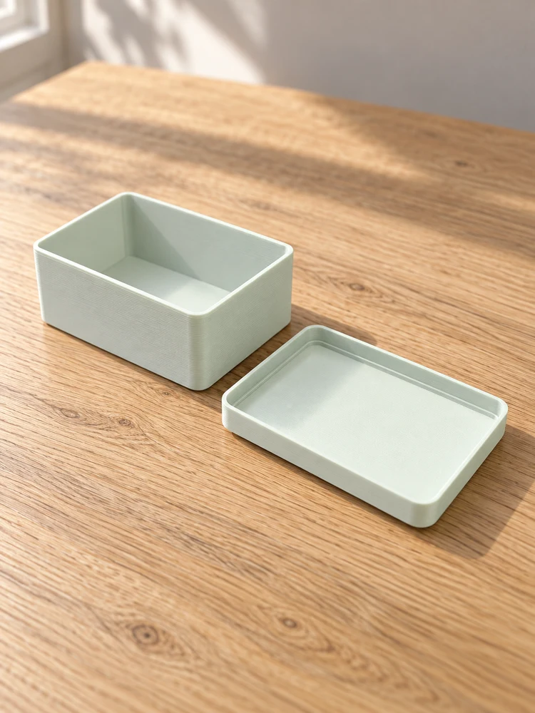 AI visualization of the matching pale mint box and lid on a light oak table