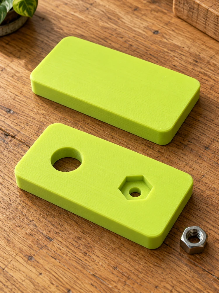 AI visualization of matching lime printed plates before and after adding a round hole and nut pocket, on an oak worktable
